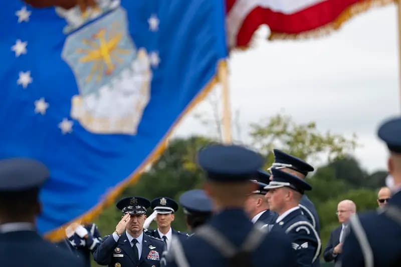 An Air Force honor guard folds the flag during military funeral honors at Arlington National Cemetery